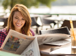 Beautiful Young Girl Reading Newspapers